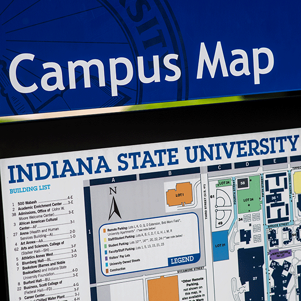 Campus map signage. The top of the sign reads “Campus Map” in white letters on blue background. Beneath that is visible a graphic sign with key text. The sign reads “Indiana State University” at the top.