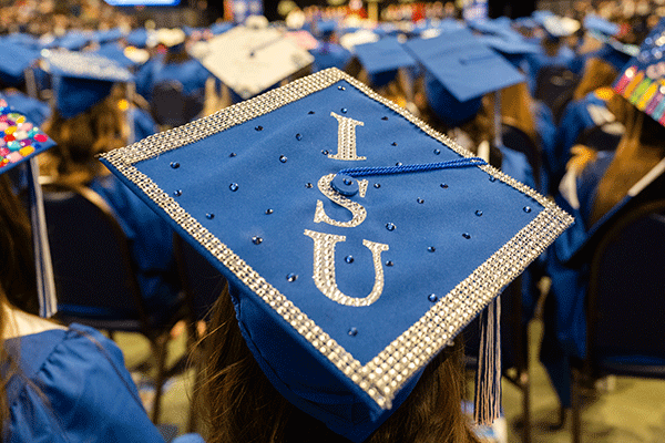 A close up of a blue cap with ISU in rhinestones