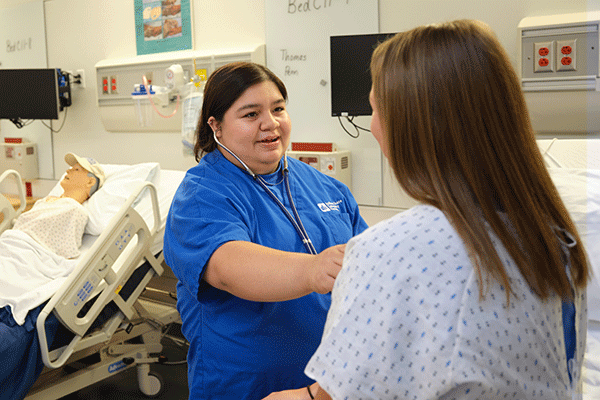 Two nursing students gain knowledge and skills in one of the Nursing Learning Resource Center skill labs at Indiana State University.