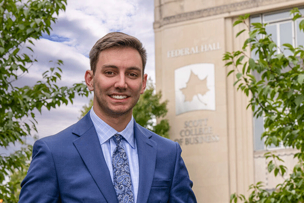 Dylan Mauplin standing in front of the Scott College of Business