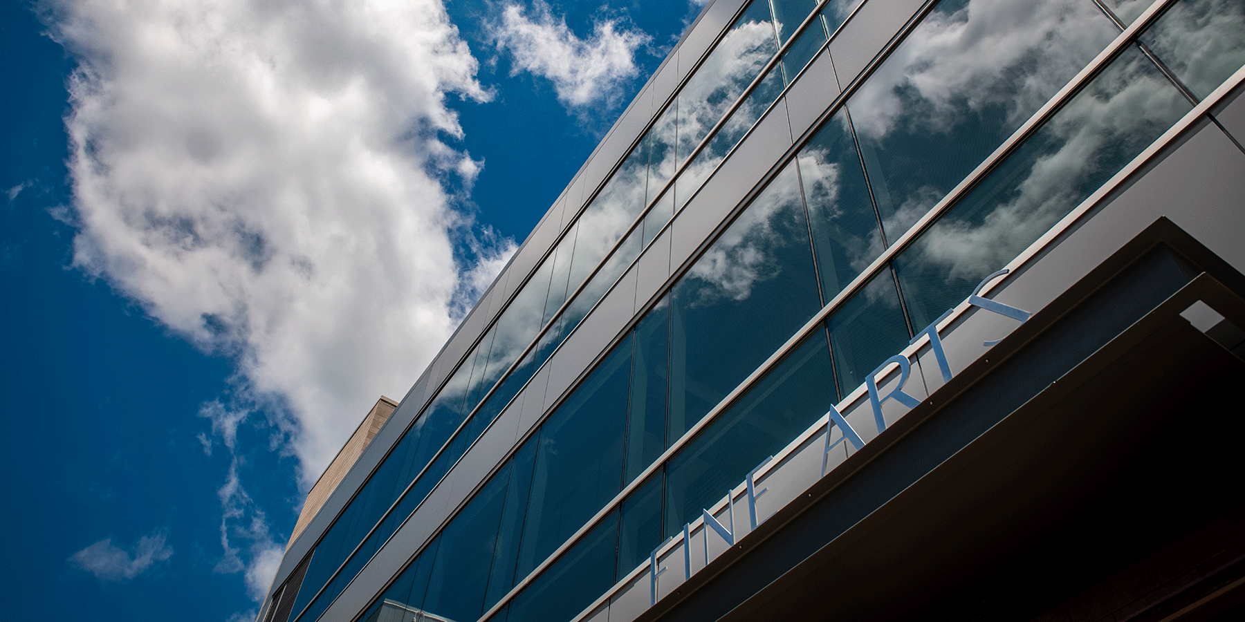 Building exterior with blue sky and clouds