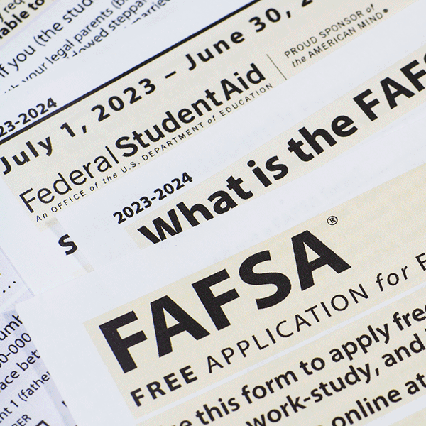 Closeup image of a FASFA form on a table with text reading “Federal Student Aid”