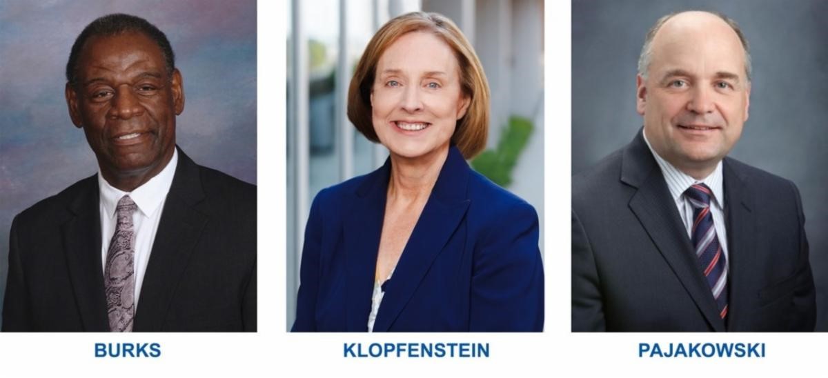 Professional portraits of three individuals. From left to right: a Black man named Burks wearing a dark suit and tie, a white woman named Klopfenstein in a blue blazer over a white blouse, and a white man named Pajakowski in a gray suit with a blue striped tie.