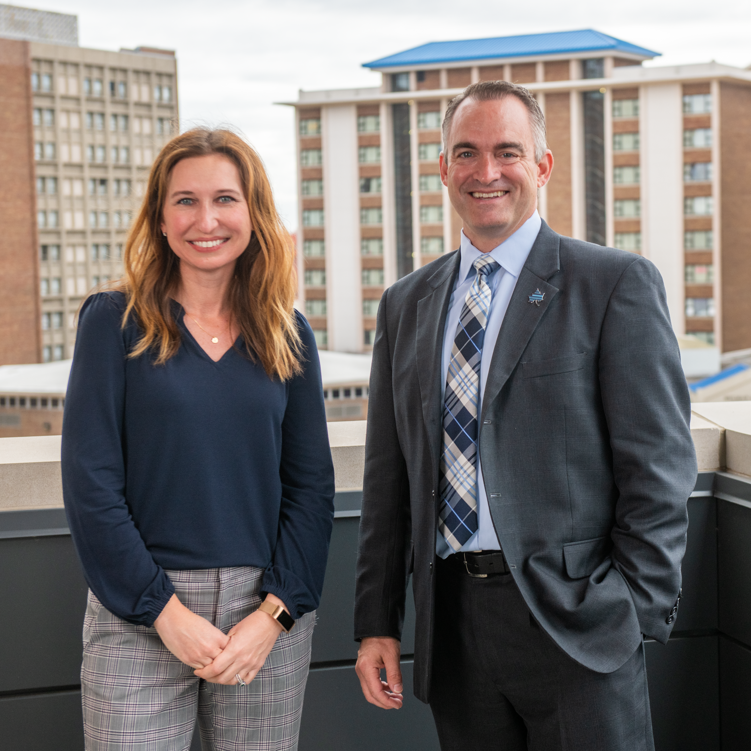 Andrea Angel and Jeremiah Turner in front of campus buildings