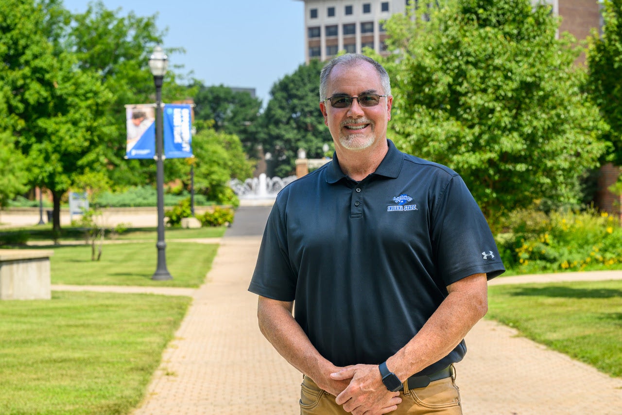 Smiling man, Jim Jensen, standing outside on Indiana State's campus