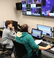 Two people working the video equipment in Sycamore Video